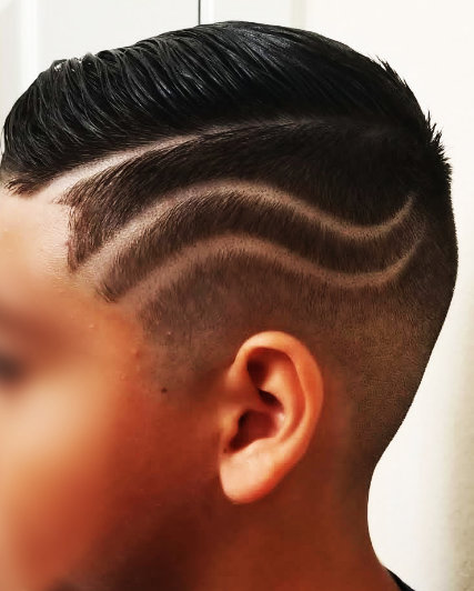 Custom fluid wave razor design on haircut at The Mane Den Barber Shop